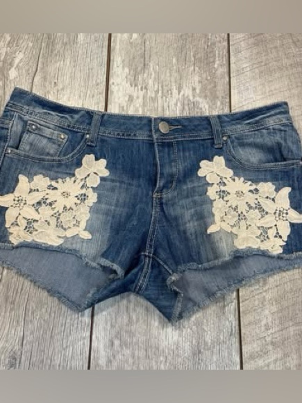 Almost Famous women’s short shorts with flower lacing medium wash and size 13